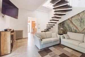 a living room with two chairs and a staircase at Le Querce Dell'Etna B&B in Ragalna