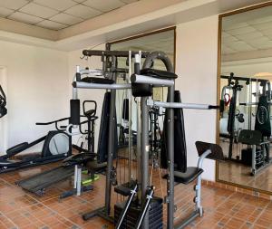 a gym with a bunch of tread machines in a room at Hotel Inn Galerias in Aguascalientes
