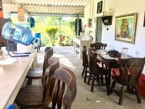 a dining room with a table and wooden chairs at NUEVO- Finca La Belleza-Villeta in Villeta