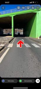 a red arrow on a road with a bridge at Hautea Bungalow in Faaa