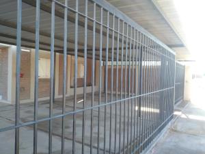 an empty room with bars on the side of a building at Complejo La Carlota in San Juan