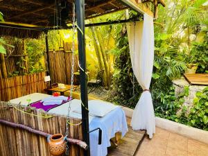a room with a bed in a garden at Hacienda Boutique B&B and Spa Solo Adultos in Cozumel