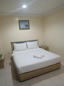 Säng eller sängar i ett rum på HOTEL AMBASSADOR 2