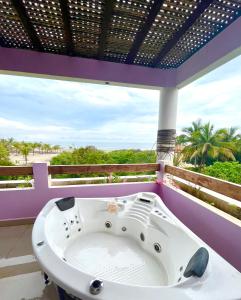 a bath tub on a balcony with a view of the beach at VILLA LA MARQUESA in Puerto Escondido