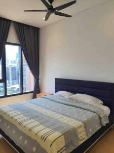 a bedroom with a blue bed with a ceiling fan at Infinity pool/ Lucentia BBCC, near LALAPORT, PNB118, KLCC in Kuala Lumpur