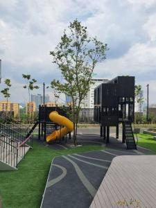 a playground with a yellow slide in a park at Infinity pool/ Lucentia BBCC, near LALAPORT, PNB118, KLCC in Kuala Lumpur
