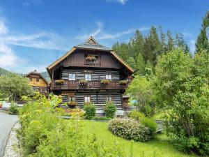 a wooden house with a balcony on the side of it at Holiday home in Bad Kleinkirchheim near ski area in Sankt Oswald