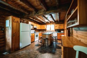 a kitchen with wooden cabinets and a white refrigerator at Afton Cabin in Afton +29 photos