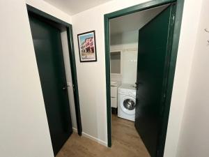 an open door to a laundry room with a washing machine at Appartement de charme avec piscine au cœur du Pays Basque - FR-1-239-795 in Urt
