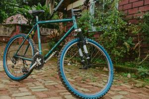 a blue bike parked next to a house at Steven and Dayness homestay in Lushoto
