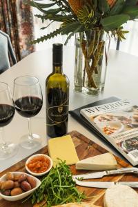 a table with a bottle of wine and two glasses at Summerfield Winery and Accommodation in Moonambel