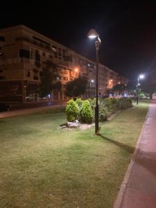 a street light on a grass field at night at Appartement avec piscine et proch de plage in Kenitra