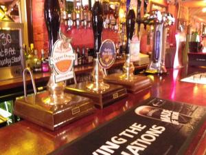 a bar with bottles of alcohol on top of it at Fifteens of Swinley in Wigan