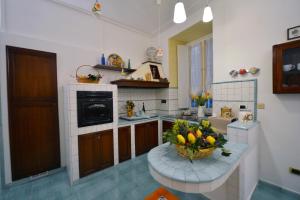 a kitchen with a bowl of fruit on a counter at B&B Sognava in Salerno