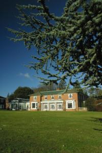 a large brick building on a grass field at Best Western Plus Kenwick Park Hotel in Louth