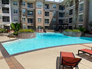 a large swimming pool in a apartment building at One bedroom apt near NRG and Medical Ctr in Houston