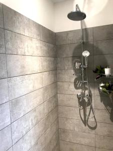 a bathroom with a shower with gray tiles at Anaiva Lodge Bora in Bora Bora