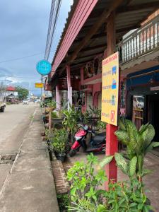 a building with a sign on the side of a street at Little Hostel in Ban Houayxay