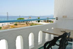 a bench on a balcony with a view of the ocean at Kokalakis Hotel in Kefalos