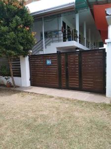 a wooden fence in front of a house at RedDoorz Buena's Pension in Puerto Princesa City