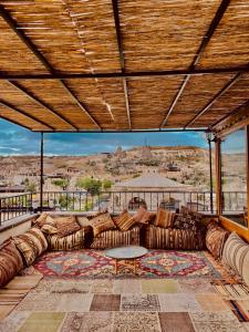 a living room with a large couch on a roof at Pashahan Hotel in Göreme