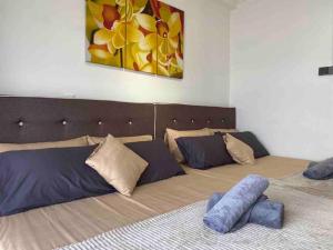 a bedroom with two beds and a painting on the wall at 2 Bedroom Apartment Next To Historical Spots in Melaka