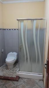 a bathroom with a toilet and a shower stall at Suta Lovina House in Lovina +27 photos