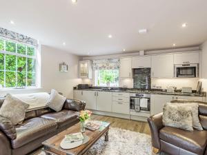 a living room with a couch and a table at Silvadale Cottage in Louth