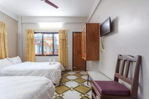 A bed or beds in a room at Hotel Immortal Inn