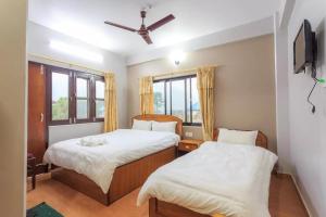 A bed or beds in a room at Hotel Immortal Inn
