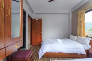 A bed or beds in a room at Hotel Immortal Inn