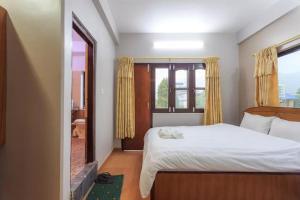 A bed or beds in a room at Hotel Immortal Inn