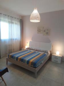 a bedroom with a bed and a chandelier at Villa Anna Maria in Polignano a Mare