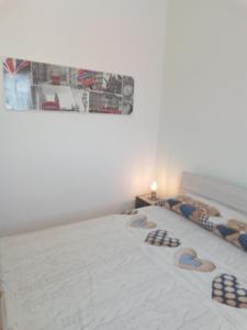 a bedroom with a bed with a picture on the wall at Villa Anna Maria in Polignano a Mare