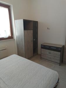 a bedroom with a bed and a dresser in it at Villa Anna Maria in Polignano a Mare