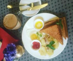 a plate of breakfast food with eggs and toast at Hotel Immortal Inn in Pokhara