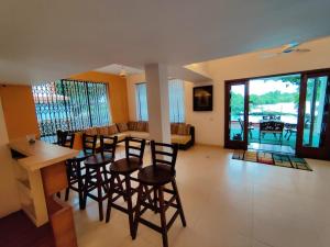 a dining room and living room with a table and chairs at Luxury 3-BHK Villa with infinity Pool in Old Goa