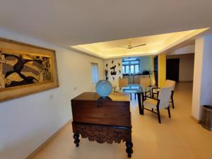 a dining room and living room with a table and chairs at Luxury 3-BHK Villa with infinity Pool in Old Goa +7 photos