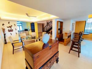 a living room filled with furniture and a dining room at Luxury 3-BHK Villa with infinity Pool in Old Goa