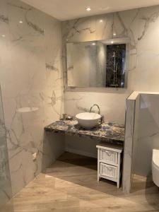 a bathroom with a sink and a mirror at Casa Martini in Bonifacio