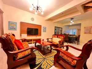a living room with two couches and a television at The Zonne Home stay Cameron Highlands in Tanah Rata