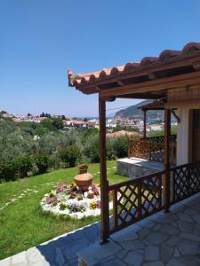 a view of a garden with a pergola at Remvi Apartments in Skopelos Town