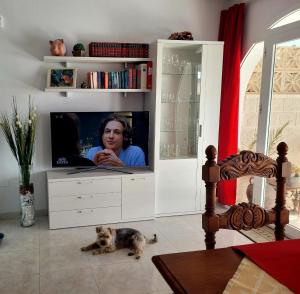 a living room with a tv in a white entertainment center at Casa Bella in Mijas Costa