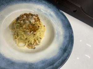 a plate of pasta with sauce and nuts on it at A 2 Passi Dagli Dei in Agerola