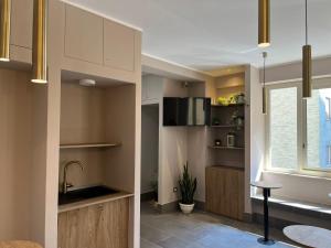 a kitchen with white cabinets and a sink and a window at Smart Rooms Naples in Naples