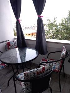 a table and chairs on a balcony with a window at Apartment Stella in Pula