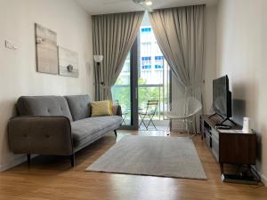 a living room with a couch and a tv at Cyberjaya amazing view Fully furnished 3 bedroom in Cyberjaya