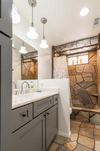 a bathroom with a sink and a mirror at Desert Ruby in Yucca Valley +59 photos
