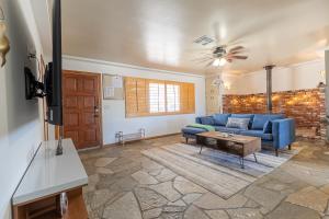a living room with a blue couch and a table at Desert Ruby in Yucca Valley