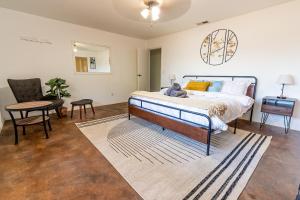 a bedroom with a bed and a table and a chair at Desert Ruby in Yucca Valley